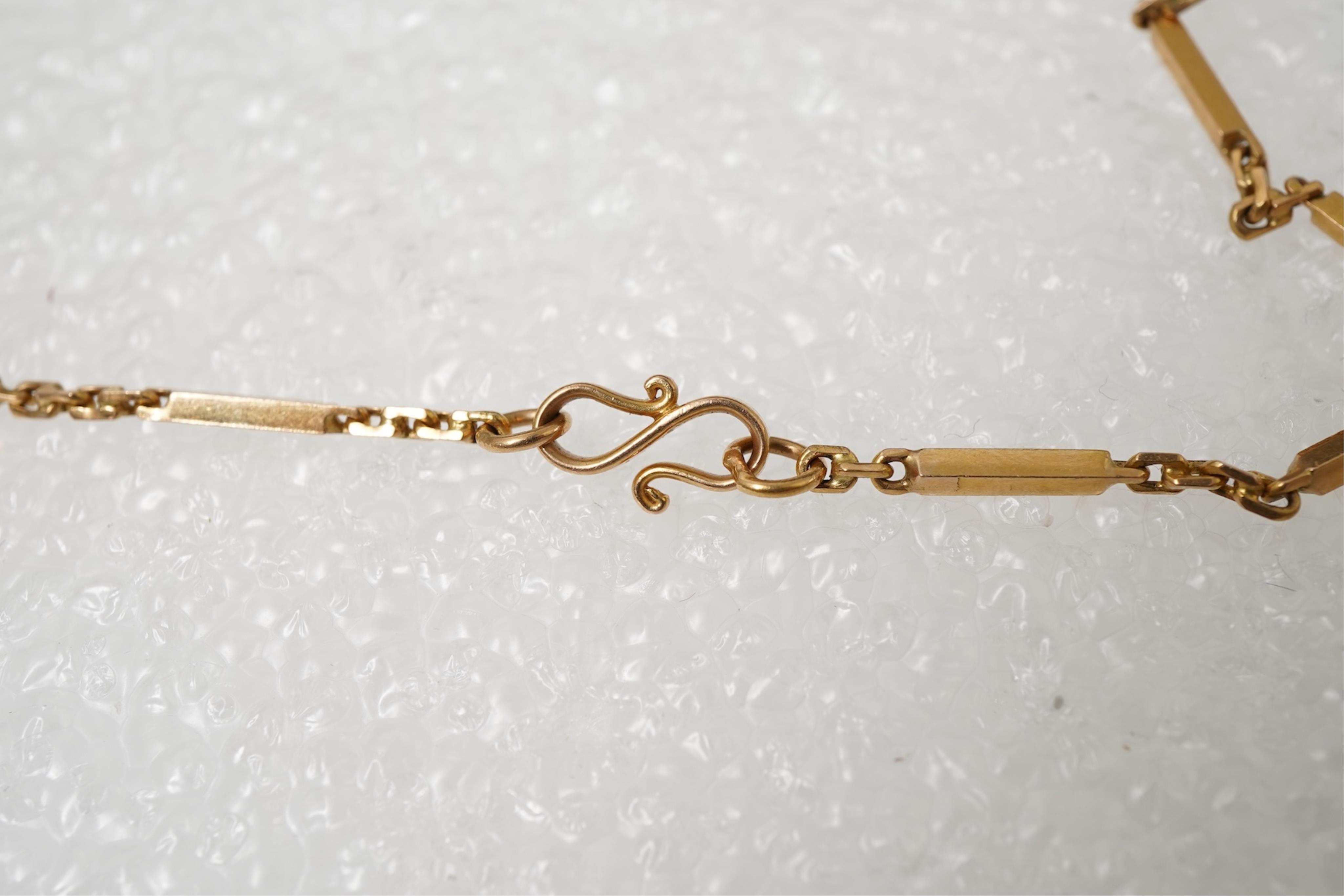 A gold zodiac pendant, mid 20th century